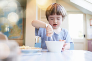 young boy eating breakfast